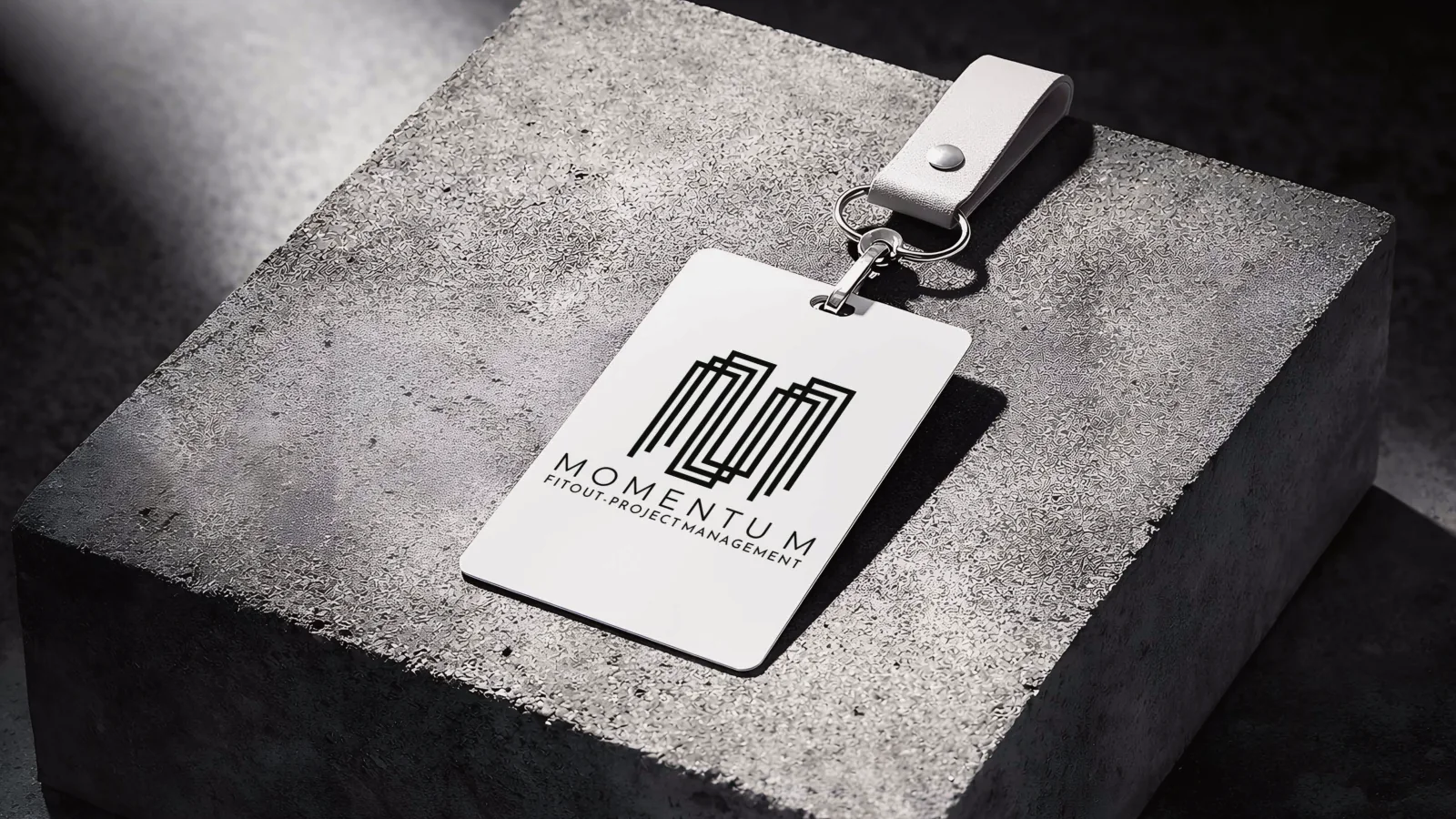 Momentum fit-out and project management logo on a staff ID card mockup
