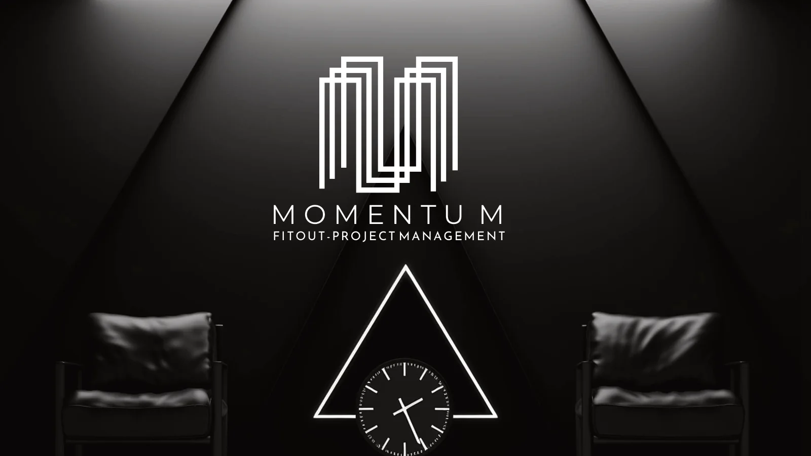 Momentum logo above a lounge with two armchairs and a wall clock